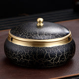 Black ceramic brass ashtray with gold accents