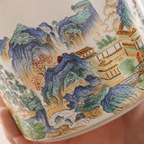 Ceramic ash tray with a scenic landscape design featuring mountains and traditional buildings.