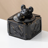 Black gold covered ceramic ashtray with ram head knob and raised side relief design