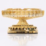 Champagne glass ashtray with ornate gold metal stand on white background