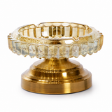 Golden bronze faceted glass ashtray with metal stand on white background