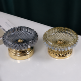 Smoke gray and amber faceted glass ashtrays with metal stands on tabletop