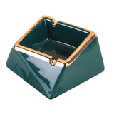 Emerald green ceramic ashtray with gold trim and 2 grooves to rest cigarettes