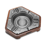 Antique silver hexagon cigar ashtray with wood base on white background