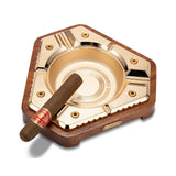 Brushed gold cigar ashtray with cigar rest and solid wood base