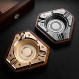 Brushed gold and silver hexagon cigar ashtrays shown together in a finish comparison