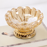 Champagne scalloped glass ashtray displayed on decorative book
