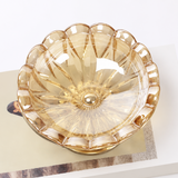 Top view of Champagne scalloped glass ashtray with flower inspired design