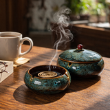 Large vintage ceramic ashtrays for with lid on wooden table with burning incense coil and smoke