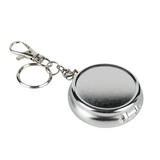 A silver metallic round keychain pocket ashtray with a clasp and key ring, shown on a plain white background.