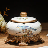 Cream bird and floral ceramic ashtray with lid and decorative bronze stand