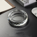 Transparent round glass ashtray modern clean design on table