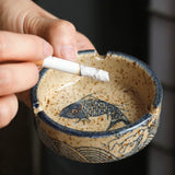 ceramic fish ashtray in use cigarette holder groove detail