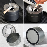 Outdoor ashtray with rotatable lid placed on a table in a lifestyle setting